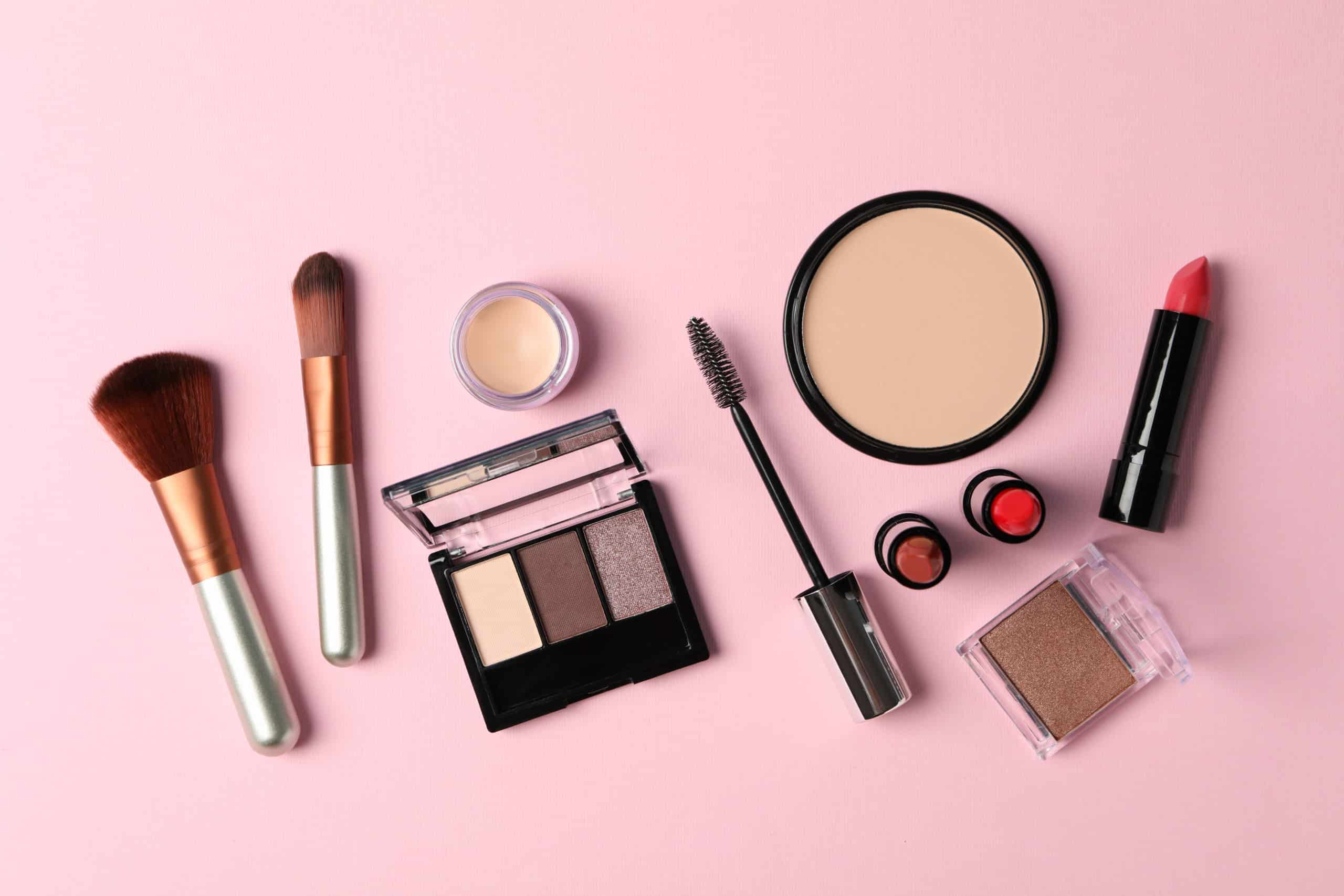 Different makeup cosmetics on pink background. Female accessories