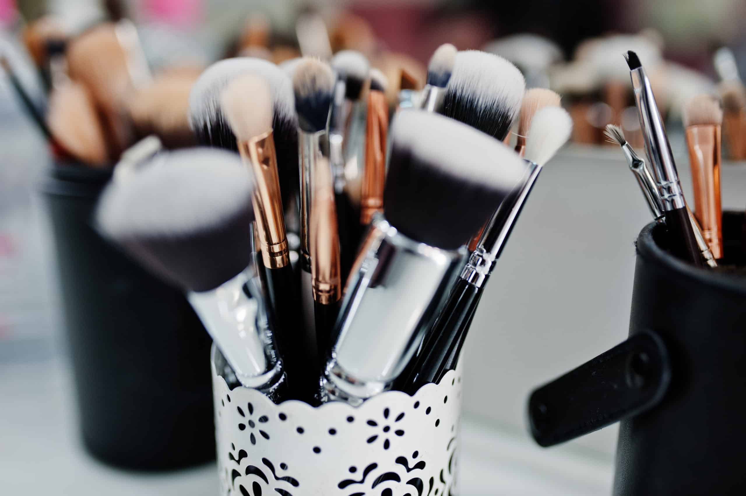 Many brushes on a table in the salon. Workplace makeup artist. Set of brushes for makeup.